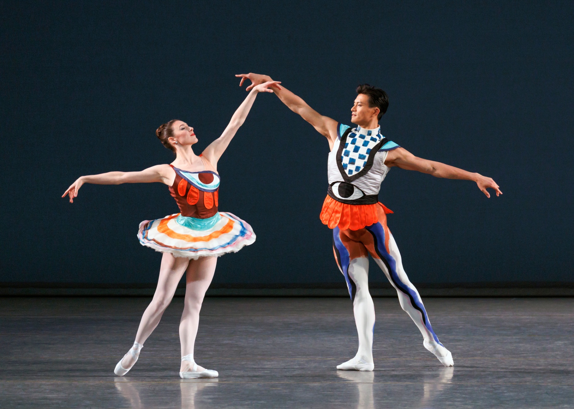 Pulcinella Variations series — Pulcinella Variations — extended pas de deux with arms reaching skyward against deep blue