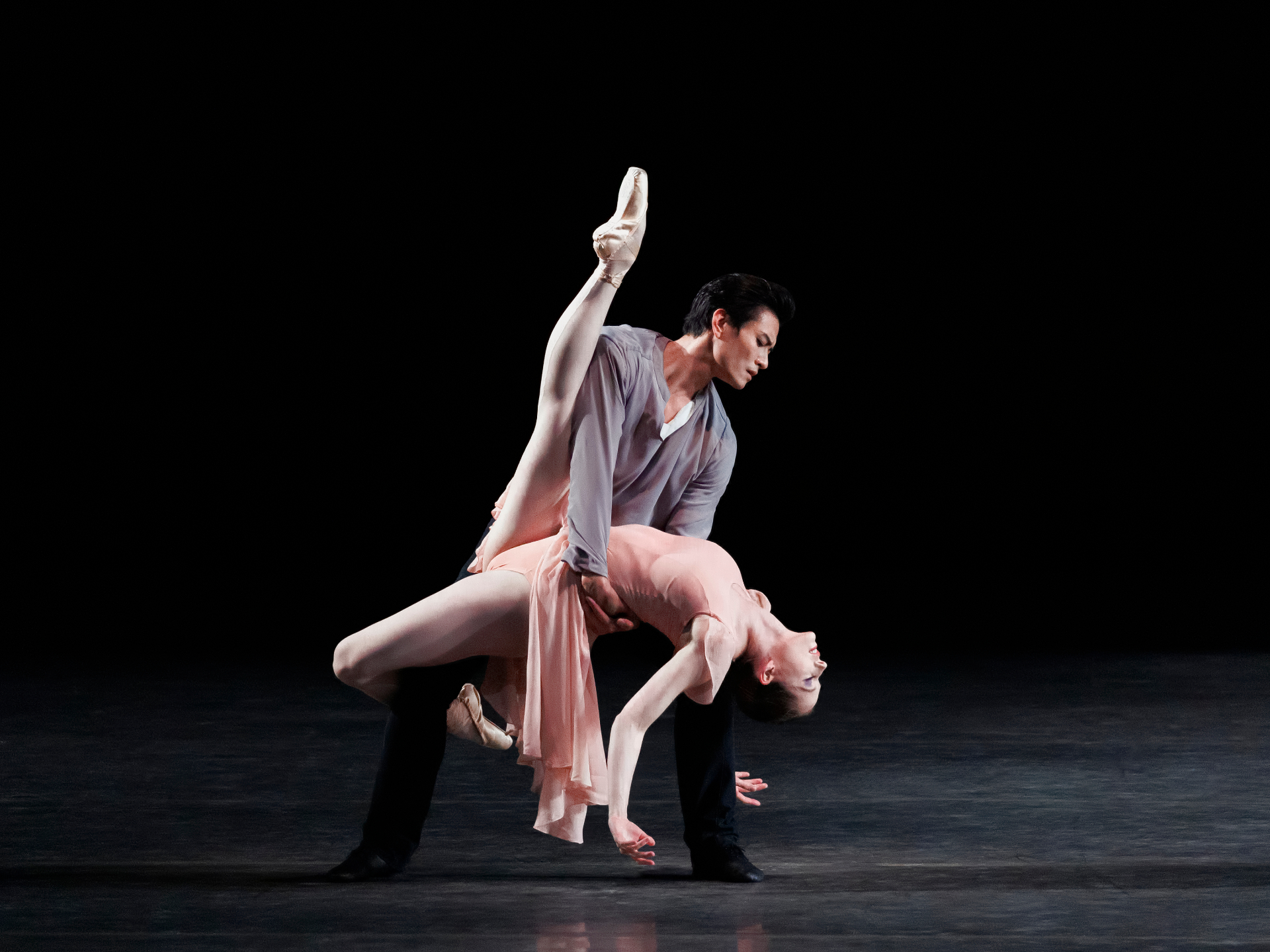 In Memory Of… series — In Memory Of… — partnered backbend with leg extended skyward in pink and grey against black