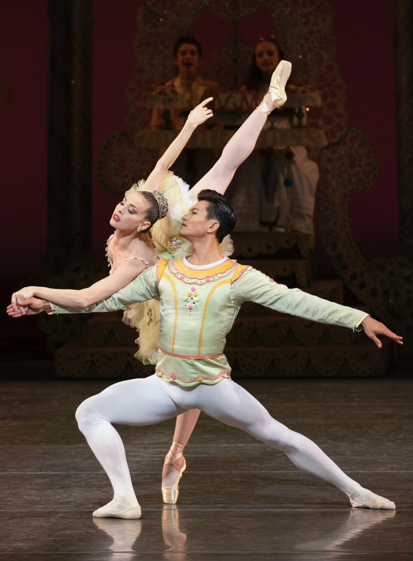 George Balanchine's The Nutcracker series — The Nutcracker — Cavalier partnering Sugarplum Fairy in arabsque penché before the candy throne
