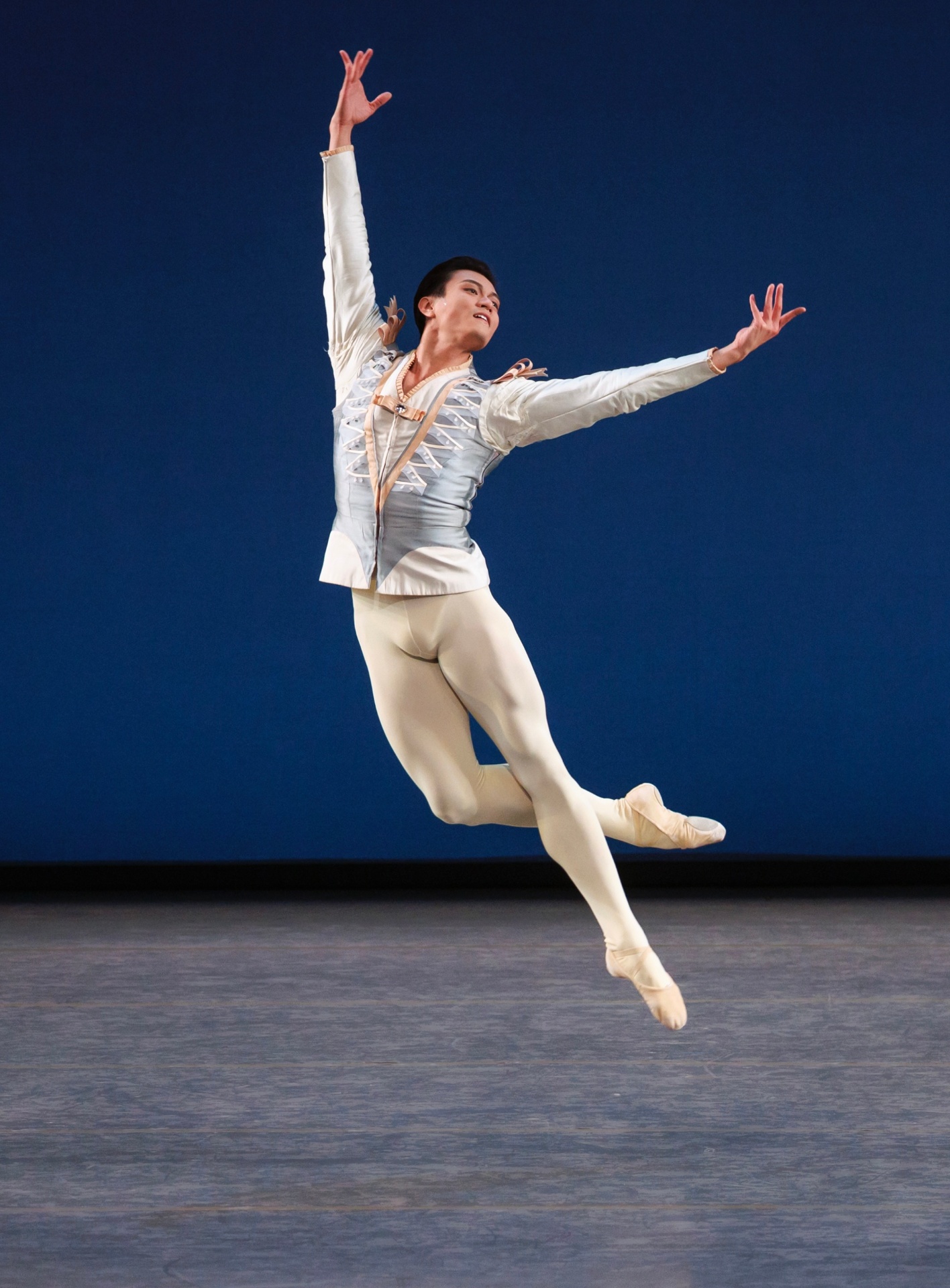 Divertimento No. 15 series — Divertimento No. 15 — soaring solo leap in pale blue cavalier costume against deep blue