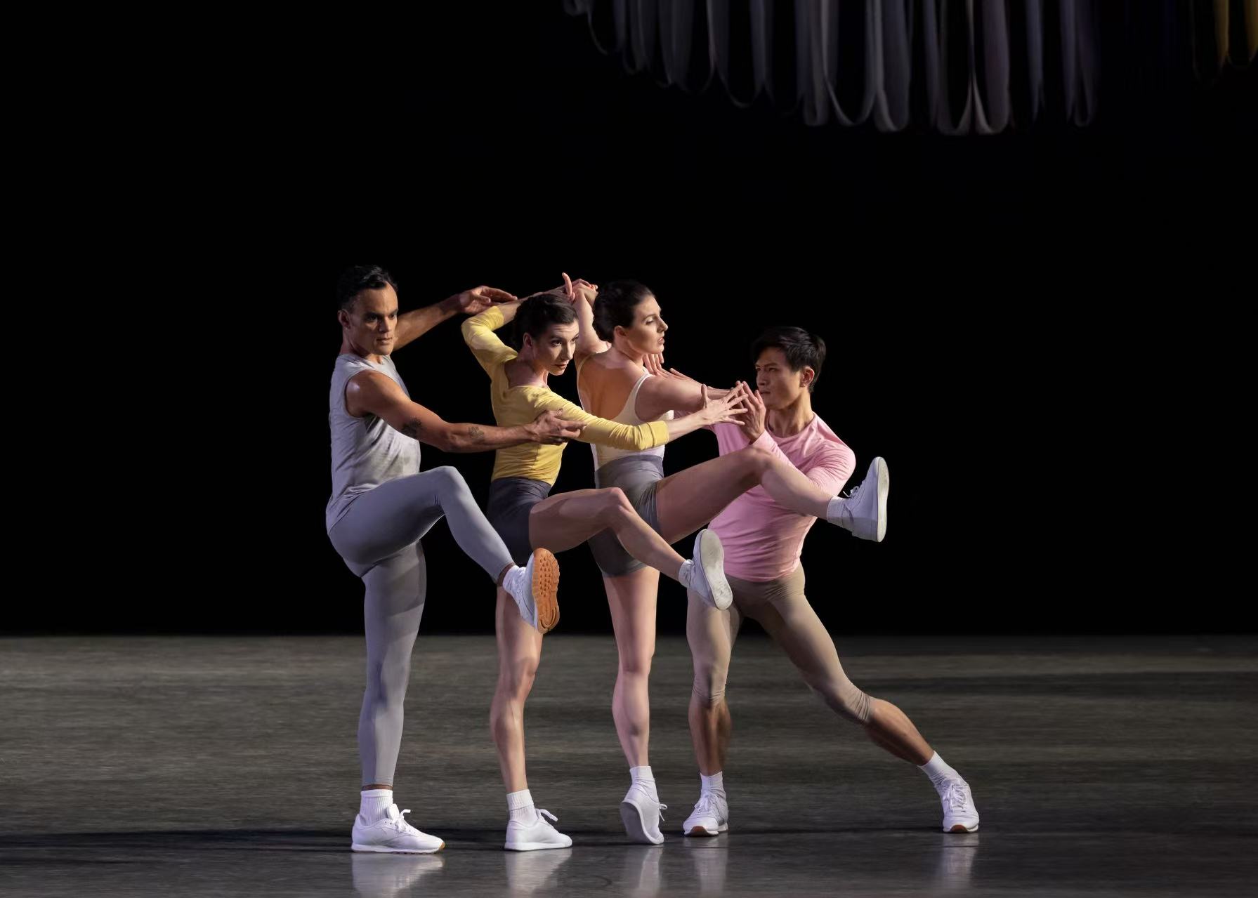 Partita series — Partita — quartet in pastel tops and sneakers, intertwined gesture